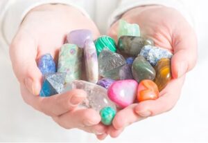 Woman-holding-hand-full-of-healing-crystals